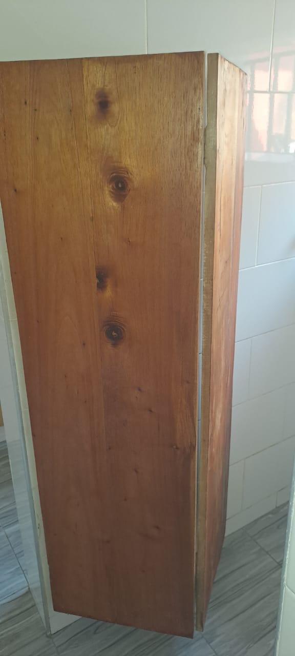 A unique, curved wooden bendable door, demonstrating custom woodworking for a bathroom or tight space.