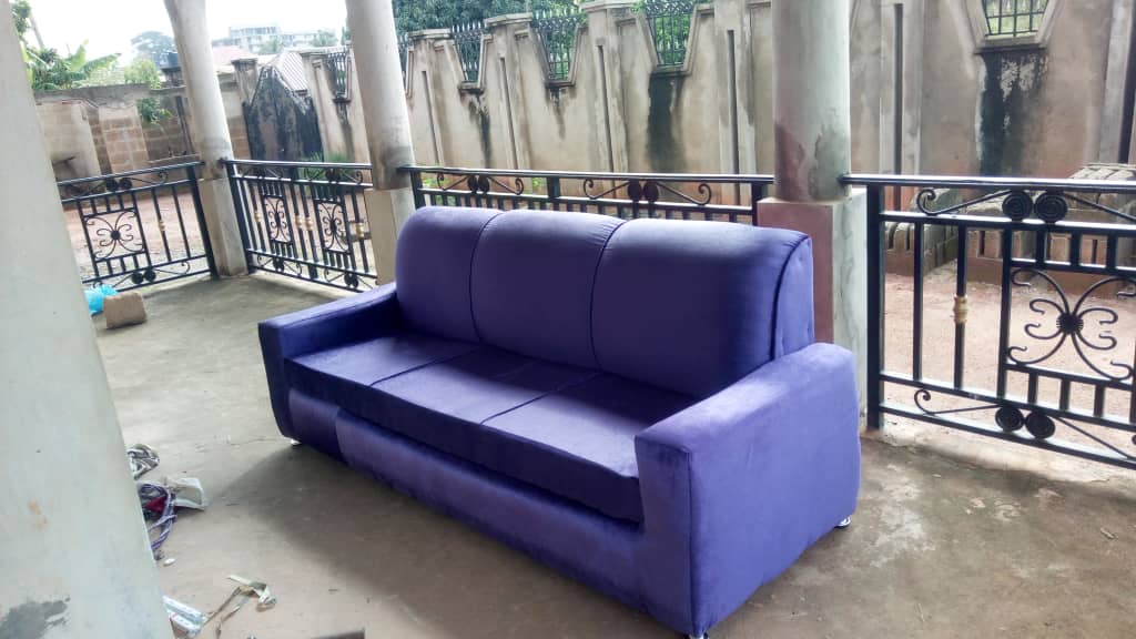 A vibrant purple custom-made upholstered sofa sitting on a patio.